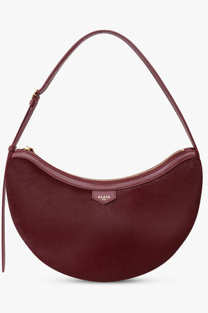 Alaïa Demi Lune Hair Calf Bag in Garnet Red