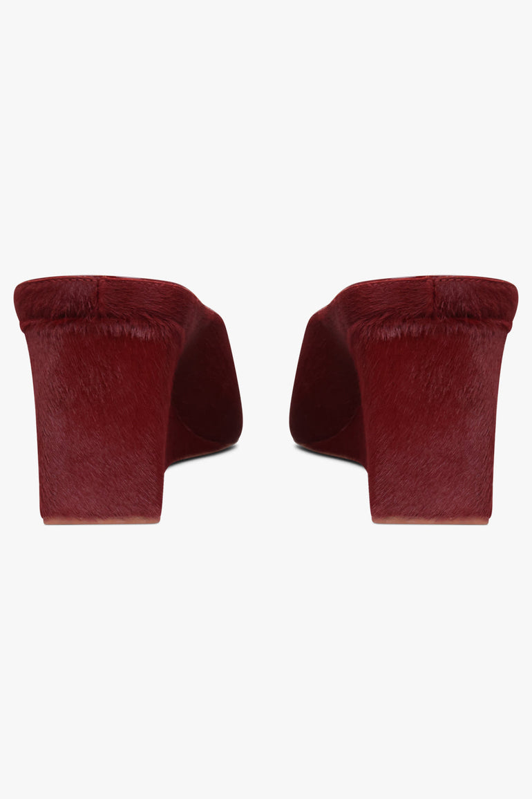 Alaïa Wedge 75mm Calf Hair Mules in Cherry Red